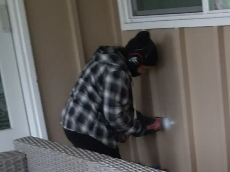 Professional electrician installing an exterior outlet in Bartlett
